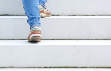 Female walking upstairs on stone staircase outdoors